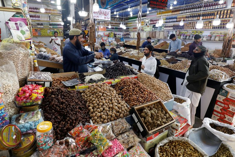 FILE PHOTO: People buy dry fruits at a market in Karachi