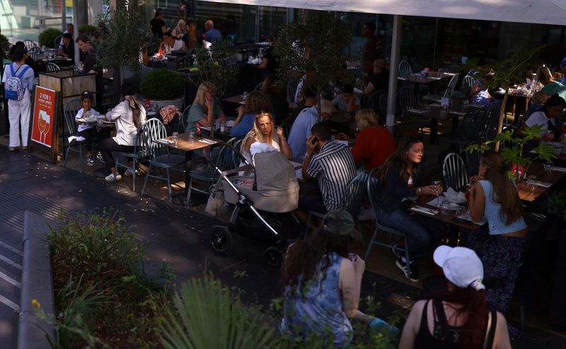 FILE PHOTO: People sit outside a restaurant on the Southbank in London, Britain, August 27, 2024. REUTERS/Hannah McKay/File Photo
