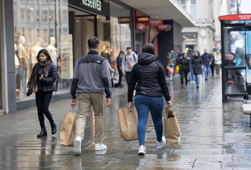 People shop on Oxford Street in London, Britain April 10, 2023. REUTERS/Anna Gordon/File Photo