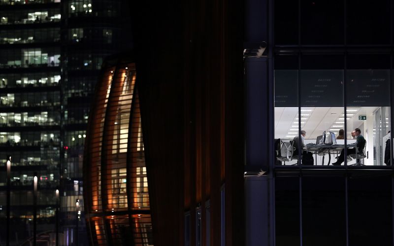 FILE PHOTO: People work in a office at Porta Nuova district downtown Milan, Italy, November 20, 2017. REUTERS/Stefano Rellandini/File Photo