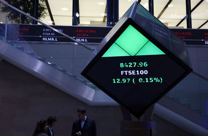 FILE PHOTO: People stand in the lobby of the London Stock Exchange in London, Britain, May 14, 2024. REUTERS/Hannah McKay/File Photo