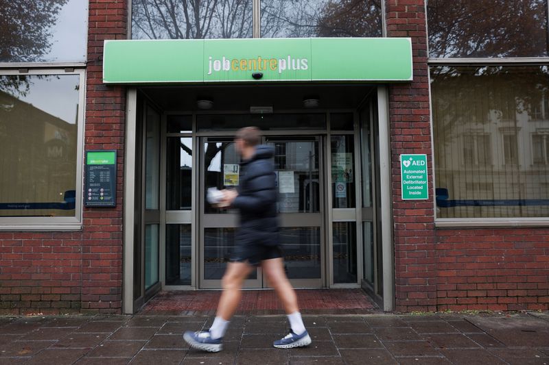 FILE PHOTO: A passer-by walks past a job centre in Borough, in London, Britain, December 1, 2024. REUTERS/Mina Kim/File Photo