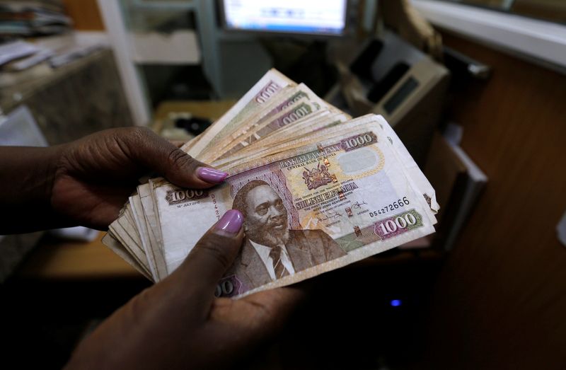 FILE PHOTO: A teller counts Kenya shilling notes inside the cashier's booth at a forex exchange bureau in Kenya's capital Nairobi, April 20, 2016. REUTERS/Thomas Mukoya/File Photo