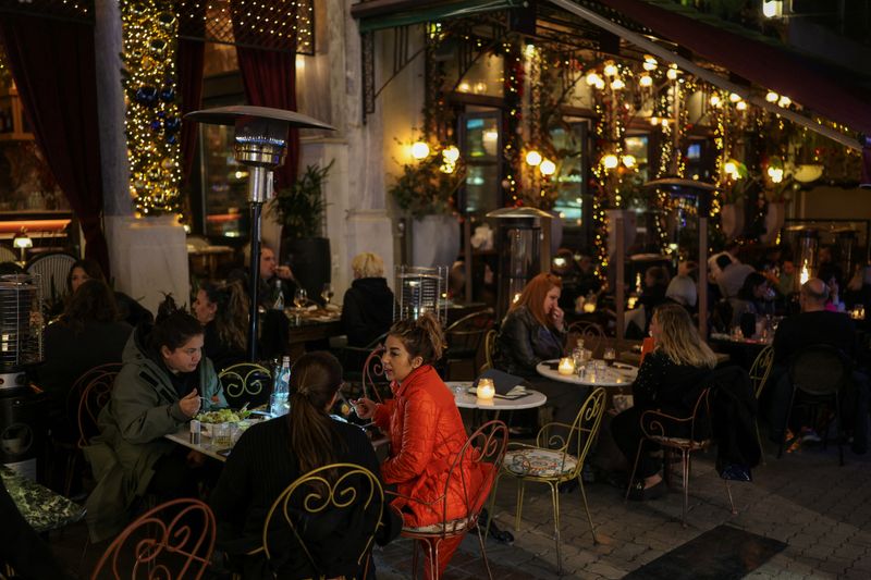 FILE PHOTO: People dine outdoors in a restaurant in Athens, Greece, January 9, 2025. REUTERS/Stelios Misinas/File Photo