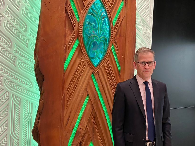 FILE PHOTO: Assistant Governor Christian Hawkesby stands with an art installation of Maori forest god Tane Mahuta at the lobby of New Zealand's Central Bank building in Wellington, New Zealand September 22, 2021. Picture taken September 22, 2021. REUTERS/Praveen Menon/File Photo
