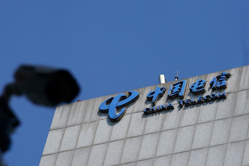 FILE PHOTO: Sign of China Telecom is pictured near a security camera in Beijing