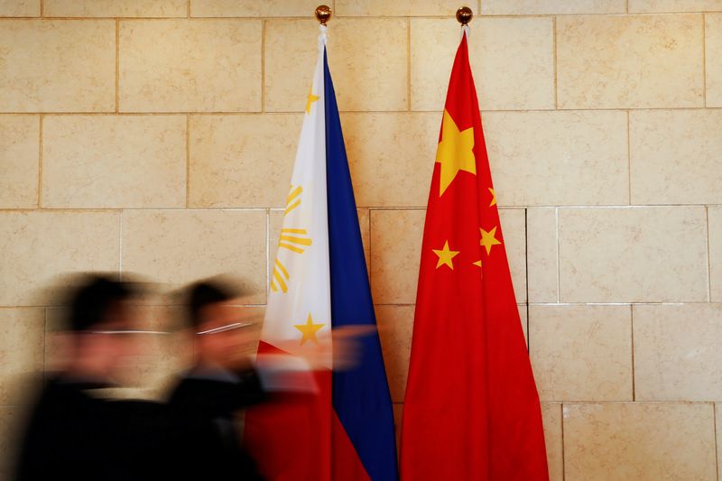 National flags are placed outside a room where Philippine Finance Secretary Carlos Dominguez and China’s Commerce Minister Gao Hucheng address reporters after their meeting in Beijing