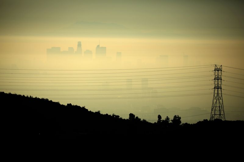 Downtown Los Angeles is seen behind an electricity pylon through the morning marine layer in Los Angeles