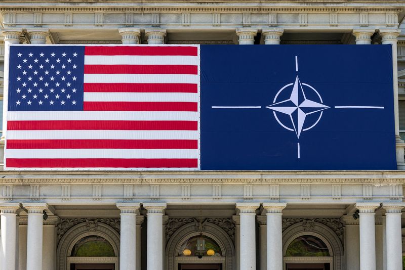 FILE PHOTO: A view of the U.S. flag alongside the NATO flag outside the Eisenhower Executive Office Building in Washington, U.S., July 8, 2024. REUTERS/Kevin Mohatt/File Photo
