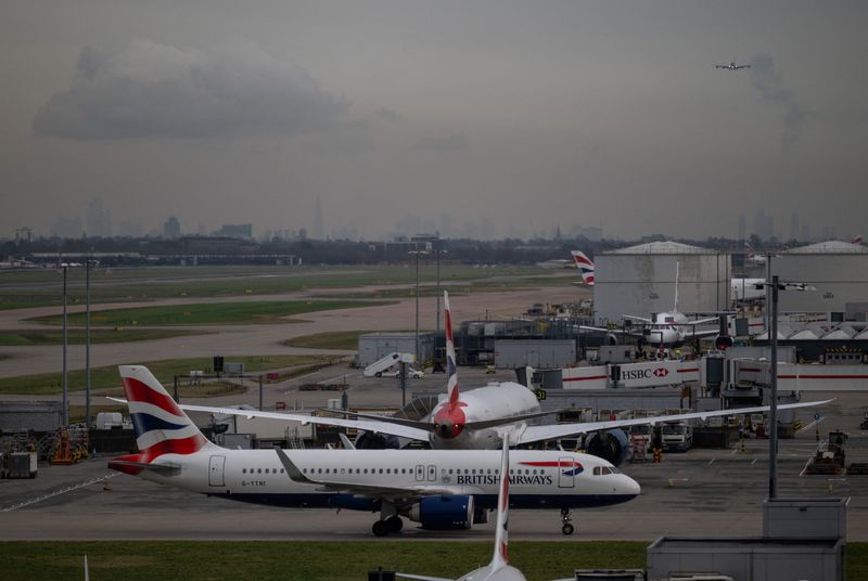 FILE PHOTO: A passenger plane approaches a runway at Terminal 5 of Heathrow Airport, as the London skyline is seen in the distance, in Greater London, Britain, January 29, 2025. REUTERS/Chris J. Ratcliffe/File Photo