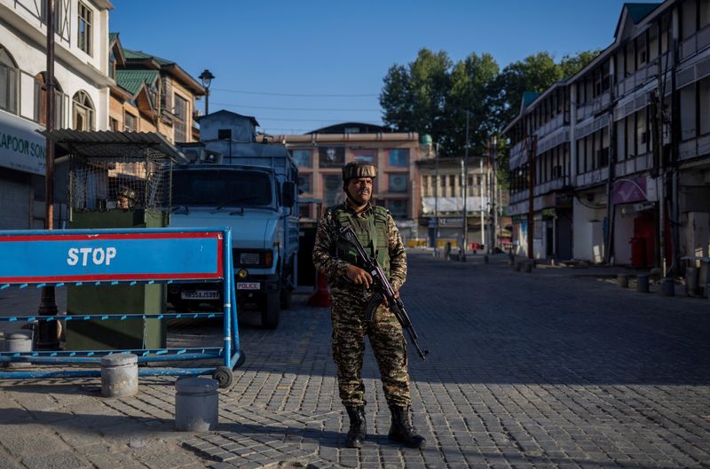 FILE PHOTO: An Indian security force personnel stands guard on a street, following an attack on tourists near Pahalgam in south Kashmir, in Srinagar, April 29, 2025. REUTERS/Adnan Abidi/File Photo