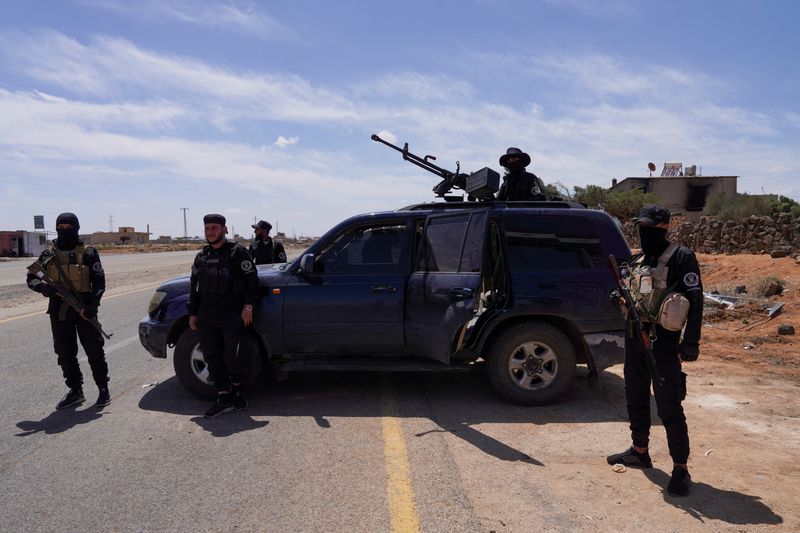 Members of Syrian security forces stand guard after being deployed in the village of Al-Soura al-Kubra, following clashes between Sunni Islamist militants and Druze fighters, in Sweida province, Syria, May 2, 2025. REUTERS/Karam Al-Masri