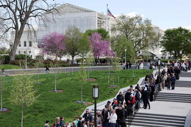 FILE PHOTO: Tourists stand in line near the U.S. Supreme Court building in Washington, D.C., U.S., April 8, 2025. REUTERS/Jonathan Ernst/File Photo
