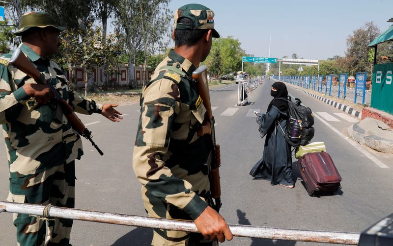 FILE PHOTO: A woman crosses a Border Security Force (BSF) checkpoint at the Attari-Wagah crossing on the India-Pakistan border near Amritsar, following Tuesday’s attack on tourists near south Kashmir’s scenic Pahalgam, India, April 25, 2025. REUTERS/Pawan Kumar/File Photo