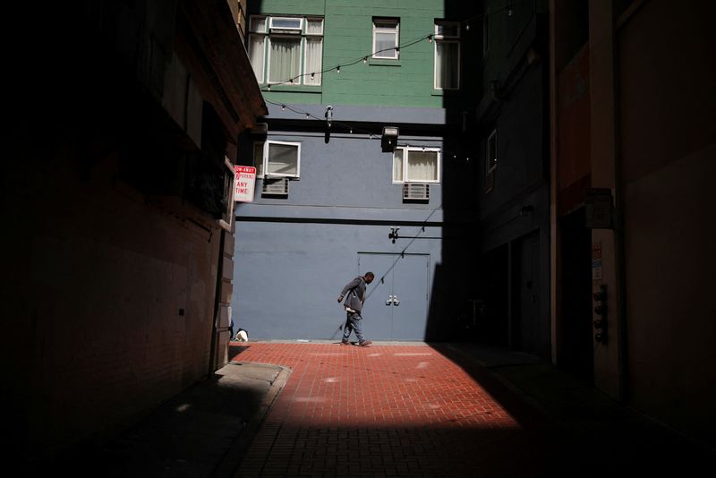 FILE PHOTO: A person addicted to fentanyl walks down an alleyway after smoking fentanyl in the Tenderloin area of San Francisco, California, U.S. March 28, 2025. REUTERS/Daniel Cole/File Photo