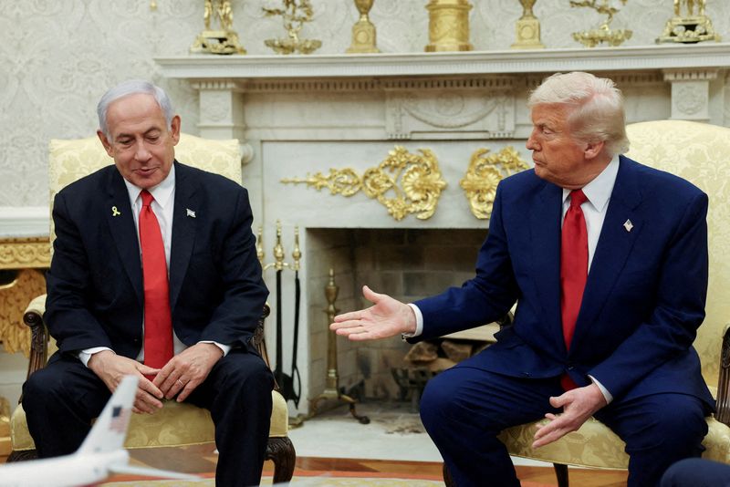 FILE PHOTO: U.S. President Donald Trump talks to Israeli Prime Minister Benjamin Netanyahu during a meeting where Trump announced nuclear talks with Iran, Washington, U.S., April 7, 2025. REUTERS/Kevin Mohatt/File Photo