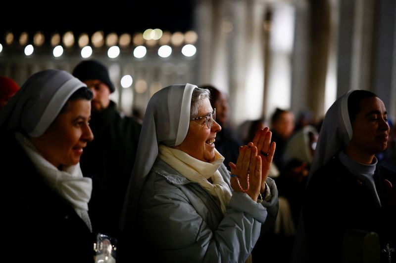 Faithful listen to an audio message by Pope Francis at the Vatican