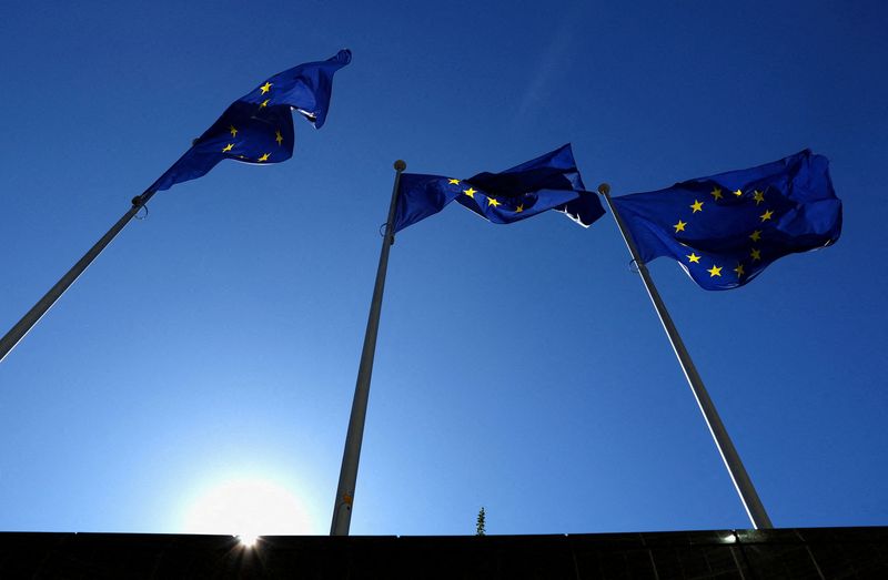 FILE PHOTO: European Union flags flutter outside the EU Commission headquarters in Brussels, Belgium March 18, 2025. REUTERS/Yves Herman/File Photo