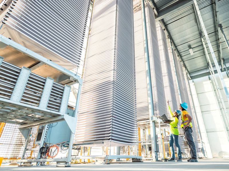 FILE PHOTO: A person points at a stack of trays holding treated limestone, used to absorb CO2 form the air, at Heirloom's new plant, in Tracy, California, in this handout picture obtained by Reuters on November 9,2023. Heirloom Carbon/Handout via REUTERS/File Photo