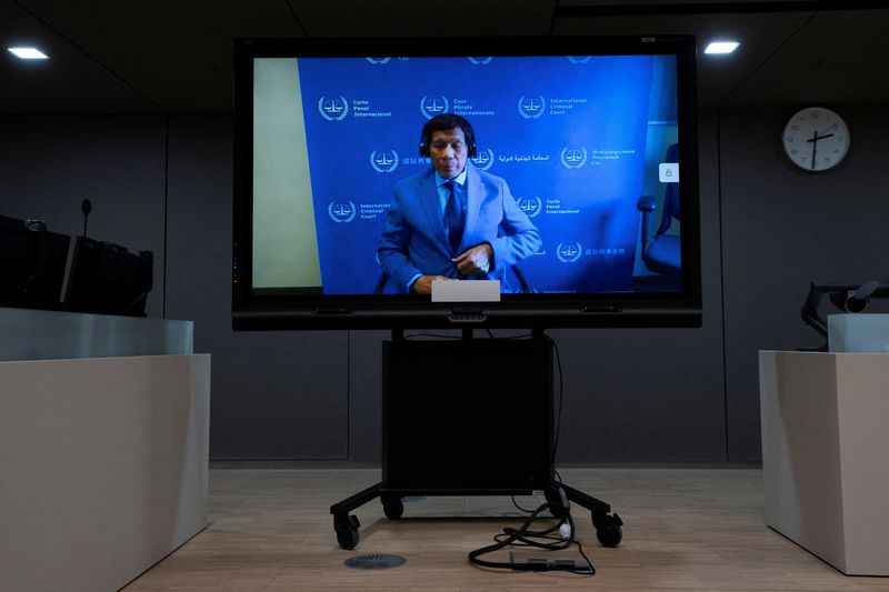 FILE PHOTO: Former Philippine President Rodrigo Duterte is seen on a screen in the courtroom of the International Criminal Court (ICC) in The Hague, Netherlands, Friday, March 14, 2025. Peter Dejong/Pool via REUTERS/File Photo