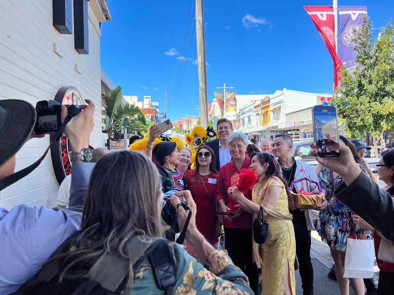 FILE PHOTO: Australia's Labour party MP for Bennelong Jerome Laxale and Australian Foreign Minister Penny Wong pose for pictures with residents, during Chinese New Year celebrations, at Eastwood in Sydney, Australia, February 2, 2025. REUTERS/Stella Qiu/File Photo