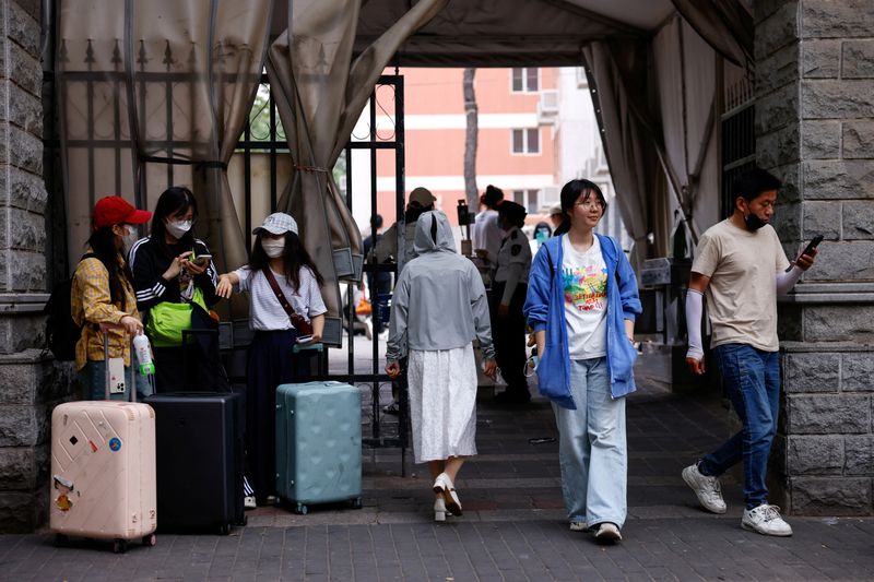 Postgraduate student Lainey, who is waiting to resume visa process to study a PhD in the U.S., walks out of her university campus, during an interview with Reuters, in Beijing, China May 30, 2025. REUTERS/Tingshu Wang