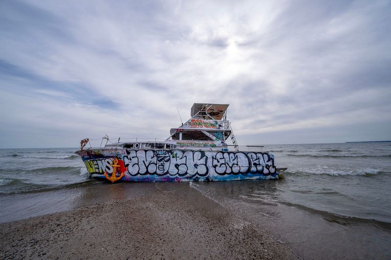 The stranded boat on the Lake Michigan shore in Milwaukee on Tuesday, March 18, 2025. The Chris-Craft Roamer named Deep Thought has been stranded by Bradford Beach since Oct. 13.