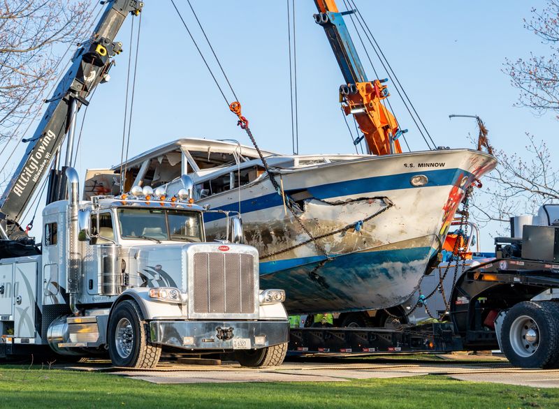 The abandoned boat "Deep Thought" is placed on a flatbed truck as they remove it from the shoreline of Lake Michigan near Bradford Beach on Tuesday May 6, 2025 in Milwaukee, Wis.